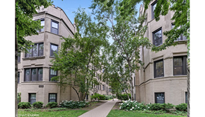 Evanston apartment for rent - a sidewalk between two apartment buildings with trees
