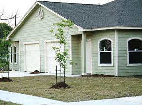 Houston apartment for rent - A green house with a white door and windows.