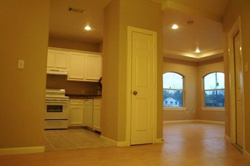 Houston apartment for rent - A kitchen with white appliances and cabinets.