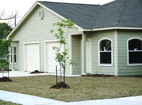 Houston apartment for rent - A green house with a white door and windows.