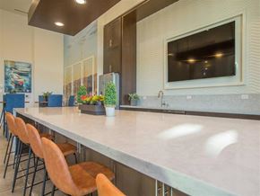Oxnard apartment for rent - a kitchen with a long counter and chairs