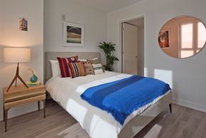 Washington apartment for rent - a bedroom with a white bed and a blue blanket