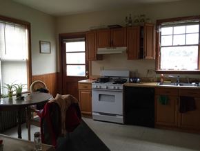 Boston apartment for rent - A kitchen with a stove and a table.