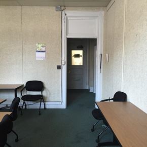 New Bedford apartment for rent - a room with desks and chairs and a door