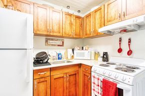 Jacksonville apartment for rent - kitchen with white appliance package, and wood cabinetry
