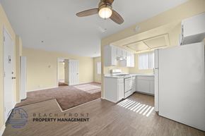Hawthorne apartment for rent - A kitchen area with a refrigerator, sink, and cabinets.