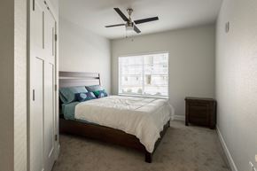 Vancouver apartment for rent - a bedroom with a bed and a ceiling fan