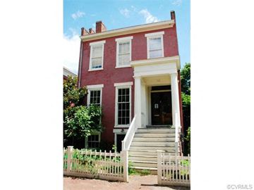 Richmond apartment for rent - a red brick house with a white fence