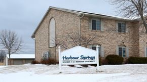 Algoma apartment for rent - a sign in front of a church in the snow