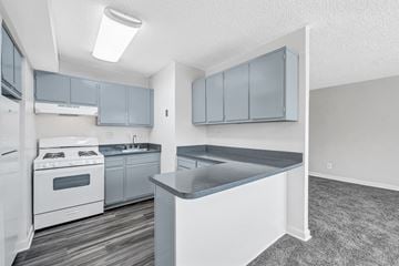 Washington apartment for rent - A kitchen with a white stove top oven and a white refrigerator.
