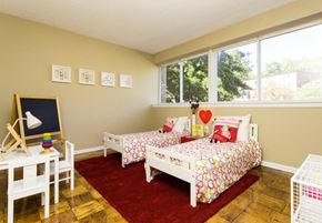 Washington apartment for rent - A room with two beds and a chalkboard on the wall.