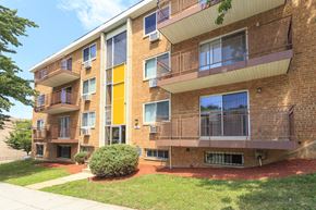 Washington apartment for rent - exterior view of a brick apartment building with balconies