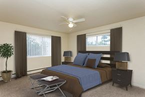 Washington apartment for rent - a bedroom with a bed and a ceiling fan