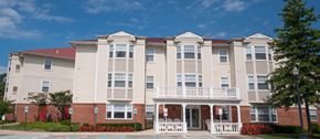 North East apartment for rent - an apartment building with white siding and red brick