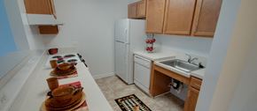 North East apartment for rent - a kitchen with a white refrigerator and a sink