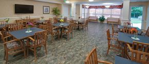 North East apartment for rent - a dining room with tables and chairs and a tv