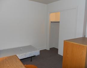 Chicago apartment for rent - a small bedroom with a bed and a closet