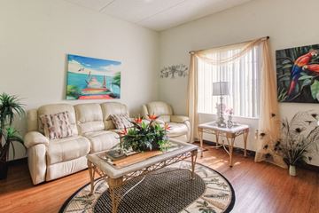 Palmetto apartment for rent - a living room with white couches and a coffee table