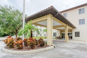 Palmetto apartment for rent - landscaped circular drive and covered entrance to Holy Cross Manor I