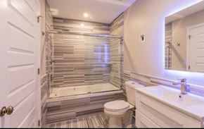 Pittsburgh apartment for rent - A white bathroom with a toilet, sink, and a walk-in shower.