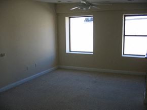 Philadelphia apartment for rent - an empty room with two windows and a ceiling fan