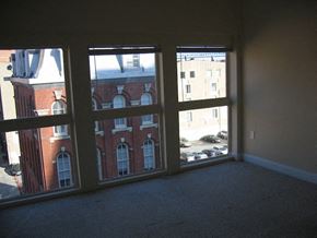 Philadelphia apartment for rent - an empty living room with three large windows