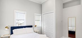 Philadelphia apartment for rent - a bedroom with a bed and two windows