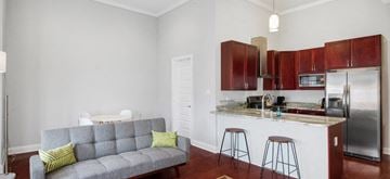 Philadelphia apartment for rent - a living room with a couch and a kitchen with a bar