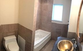Philadelphia apartment for rent - a bathroom with a toilet and a tub and a sink