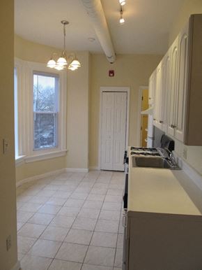 Philadelphia apartment for rent - an empty kitchen with a sink and a door