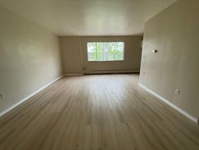 Denver apartment for rent - A room with wooden flooring and a window.