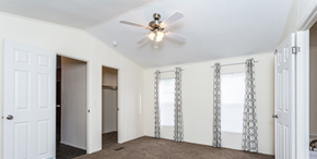 Aurora apartment for rent - a living room with white walls and a ceiling fan