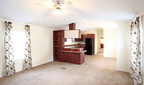 Lincoln apartment for rent - an empty living room with a kitchen and a ceiling fan