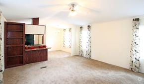 Lincoln apartment for rent - an empty living room with a cabinet and a ceiling fan