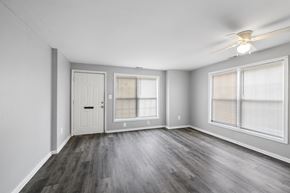 Philadelphia apartment for rent - the living room of an empty apartment with wood flooring and a ceiling fan