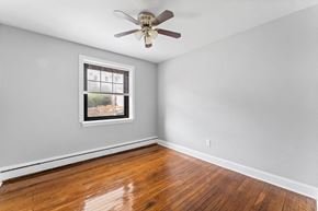 Philadelphia apartment for rent - an empty bedroom with wood floors and a ceiling fan