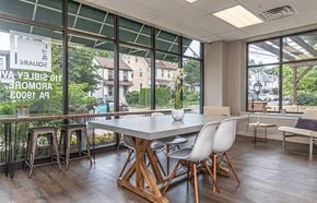 Ardmore apartment for rent - Common area with tables, chairs, and barstools in Ardmore, PA boutique apartment building