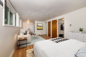 Denver apartment for rent - A bedroom with a white bed and a white dresser.