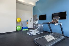 Centreville apartment for rent - a gym with cardio equipment and a tv
