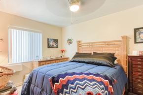 Port Charlotte apartment for rent - bedroom with ceiling fan, large window, and model furniture