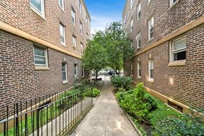 Philadelphia apartment for rent - an alleyway between two brick buildings with a sidewalk and trees