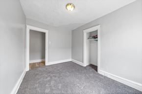 Philadelphia apartment for rent - the living room of an empty house with a carpeted floor and an open closet