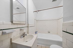 Philadelphia apartment for rent - a bathroom with a sink and a bath tub and a mirror
