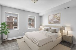 Philadelphia apartment for rent - the master bedroom has a large bed and two windows