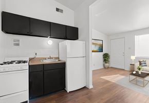 St. Louis apartment for rent - a kitchen with white appliances and black cabinets