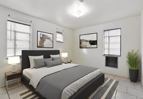 St. Louis apartment for rent - a bedroom with a bed and two windows