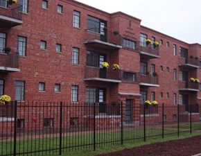 St. Louis apartment for rent - a red brick building with a fence in front of it
