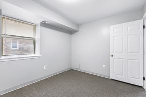 Philadelphia apartment for rent - an empty room with white walls and a window and a white door