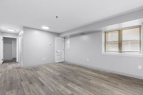 Philadelphia apartment for rent - the living room of an apartment with white walls and wood flooring
