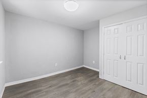 Philadelphia apartment for rent - a bedroom with white walls and wood flooring and a white door
